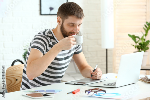 Male designer drinking coff...