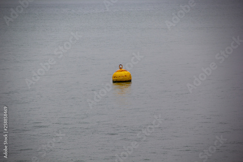 Yellow buoy saving lives in themiddle of the ocean