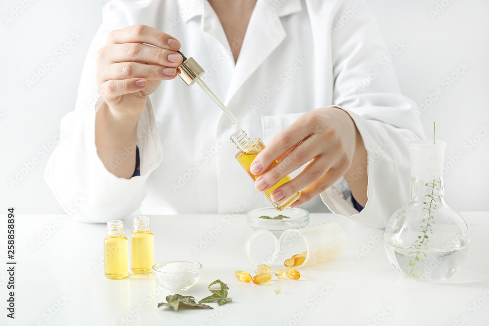 Doctor with natural essential oil at table Doctor with natural essential oil at table