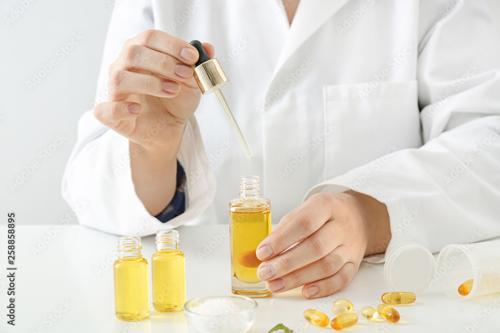 Doctor with natural essential oil at table Doctor with natural essential oil at table