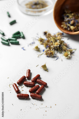 Plant based pills on white background