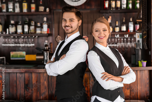 Young waiters in bar