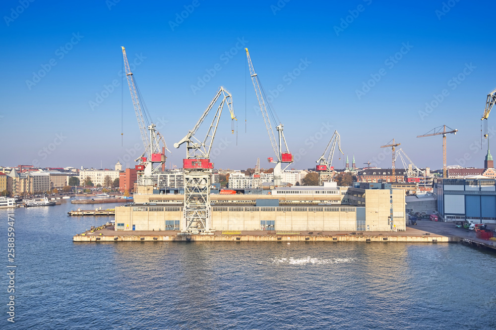 Berth cargo port with cranes on the background of the morning sky Berth cargo port with cranes on the background of the morning sky