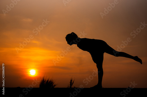 Fototapeta Naklejka Na Ścianę i Meble -  Silhouette Asia woman yoga on sunset. - Image
