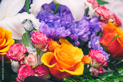 Blue chrysanthemums  orange and pink roses in a beautiful bouquet