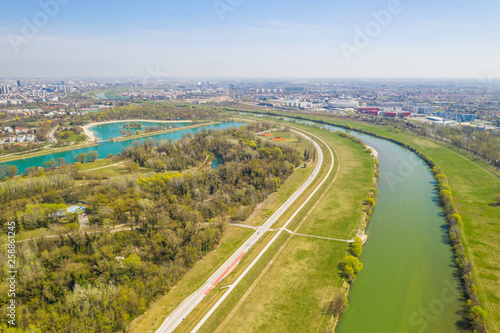 Zagreb, Croatia, Jarun lake, beautiful green recreation park area, sunny spring day, panoramic view from drone, city in background