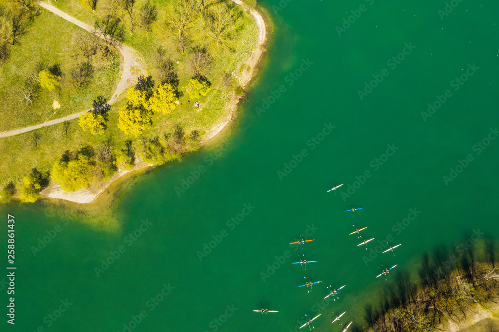 Croatia, Zagreb city, panoramic aerial view of Jarun lake from drone, overhead view, unrecognizable people paddling in kayak on beautiful green lake