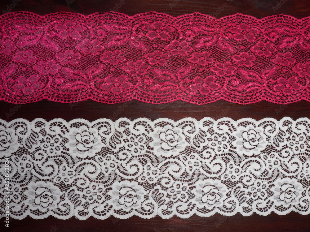 Pink and white lace on dark brown wooden background