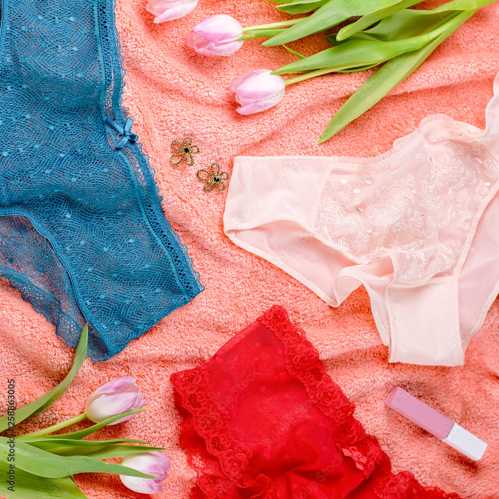 Various panties on bed background with flowers. Colorful women's underwear flatlay, top view Various panties on bed background with flowers. Colorful women's underwear flatlay, top view