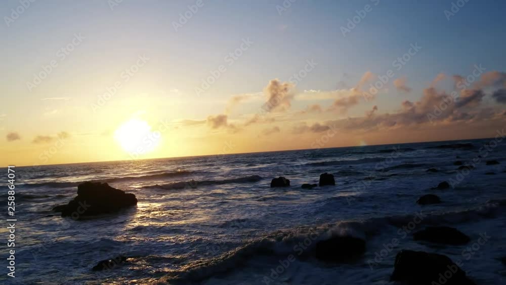 Journey to the sun setting on a Northern California Beach, Sun Rays highlight the surf breaking on weather stone. Journey to the sun setting on a Northern California Beach, Sun Rays highlight the surf breaking on weather stone.
