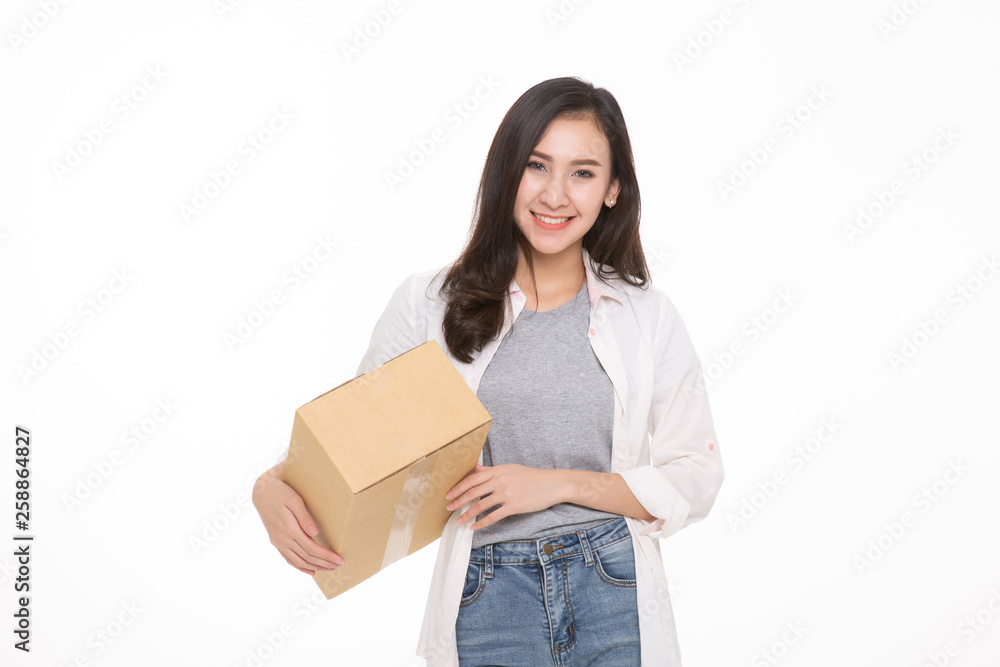 Delivery, relocation and unpacking. Smiling young woman holding cardboard box isolated on white background Delivery, relocation and unpacking. Smiling young woman holding cardboard box isolated on white background