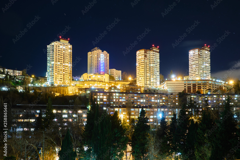 Modern high-rise residential building in Sochi at night. The Windows of the houses lit in the evening. Residential area.