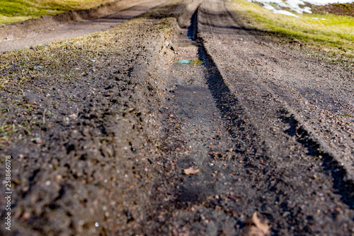 deep tire tracks in a dirt road © Jonas
