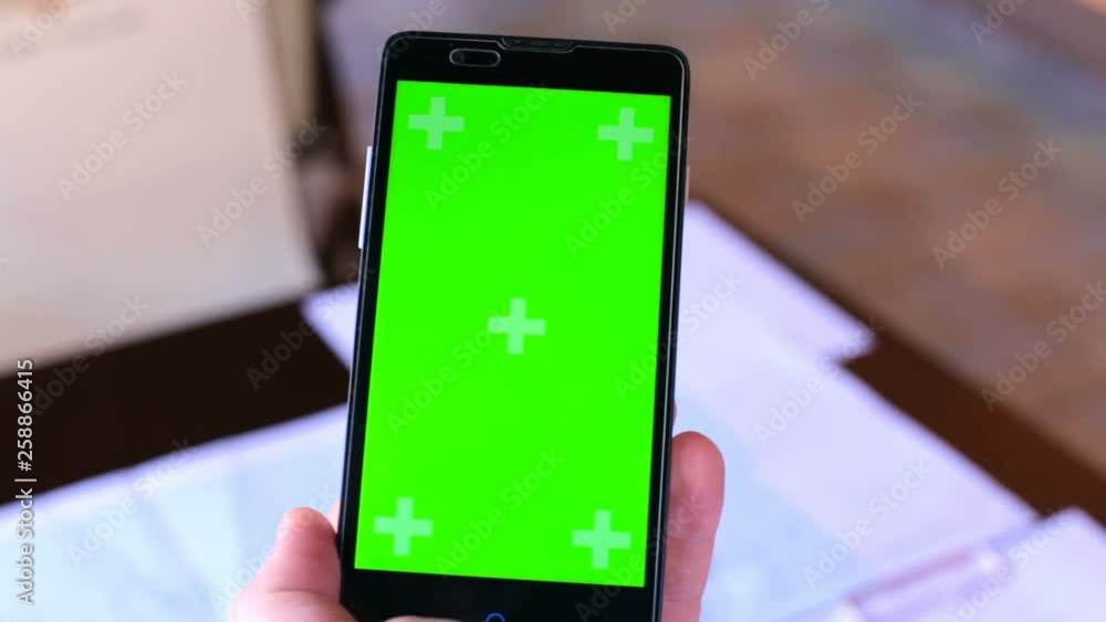 Man works on the phone with a green screen Man works on the phone with a green screen