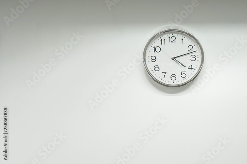 isolated round clock on office wall