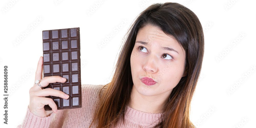 young healthy woman holding some chocolate thinking looks left young healthy woman holding some chocolate thinking looks left