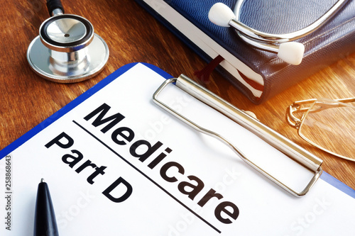 Medicare Part D documents with clipboard on a desk.