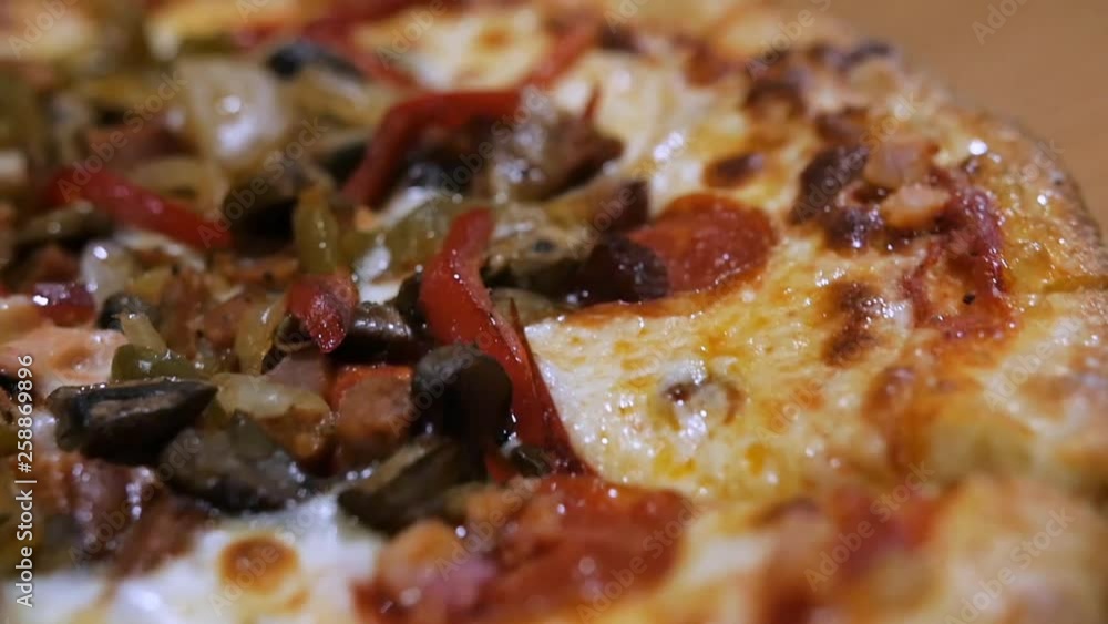 circle around pizza supreme pizza close up greasy seasoning pepporoni cheese. The camera circles around this pepperoni supreme combination pizza closeup. circle around pizza supreme pizza close up greasy seasoning pepporoni cheese. The camera circles around this pepperoni supreme combination pizza closeup.