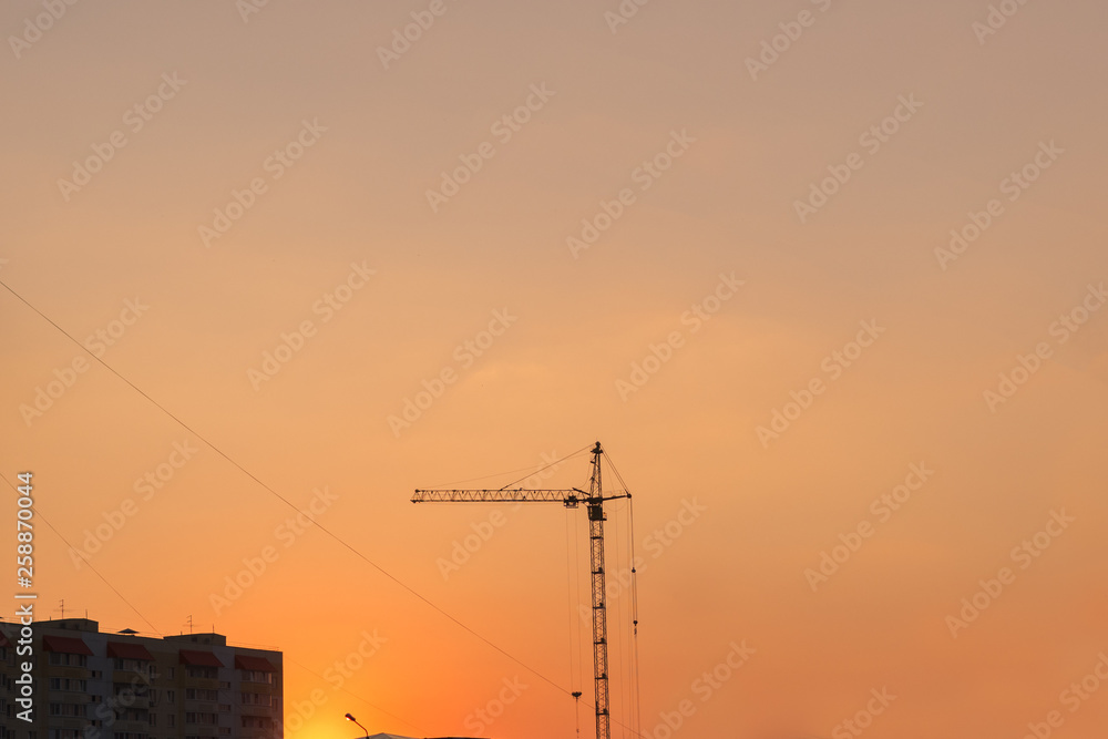 Construction crane at sunset