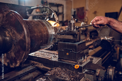 Old industrial factory worker operate Lathe machine © kerkezz