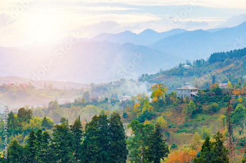 Beautiful autumn mountain landscape. Foggy morning in a hilly village. Georgia, Adjara. Aerial view at house in valley. Countryside landscape.