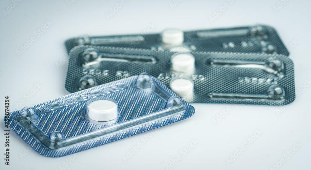 Emergency contraceptive pills in blister pack on blurred background of morning after pills. Drug cause of ectopic pregnancy. Emergency contraception for prevent pregnancy after unprotected sex. - obrazy, fototapety, plakaty 