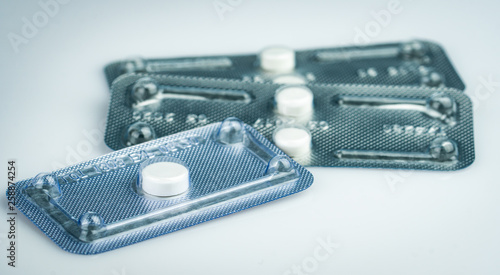 Emergency contraceptive pills in blister pack on blurred background of morning after pills. Drug cause of ectopic pregnancy. Emergency contraception for prevent pregnancy after unprotected sex. photo