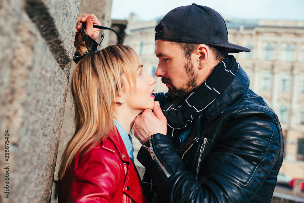 Sexy beautiful couple in leather jacket . Handsome man hugging and kissing  woman on city Stock Photo | Adobe Stock