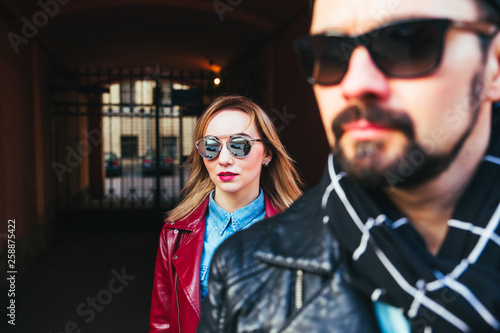 Beautiful couple of bearded man and blond young woman in sunglasses