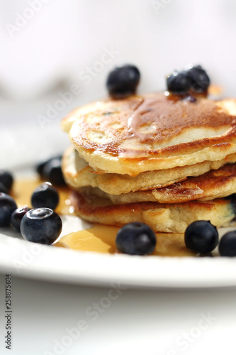  Pancakes with blueberries and maple syrup. Sweet breakfast.