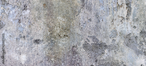 Oldgrungy weathered wall background texture. Dirty peeled plaster wall with falling off flakes of paint