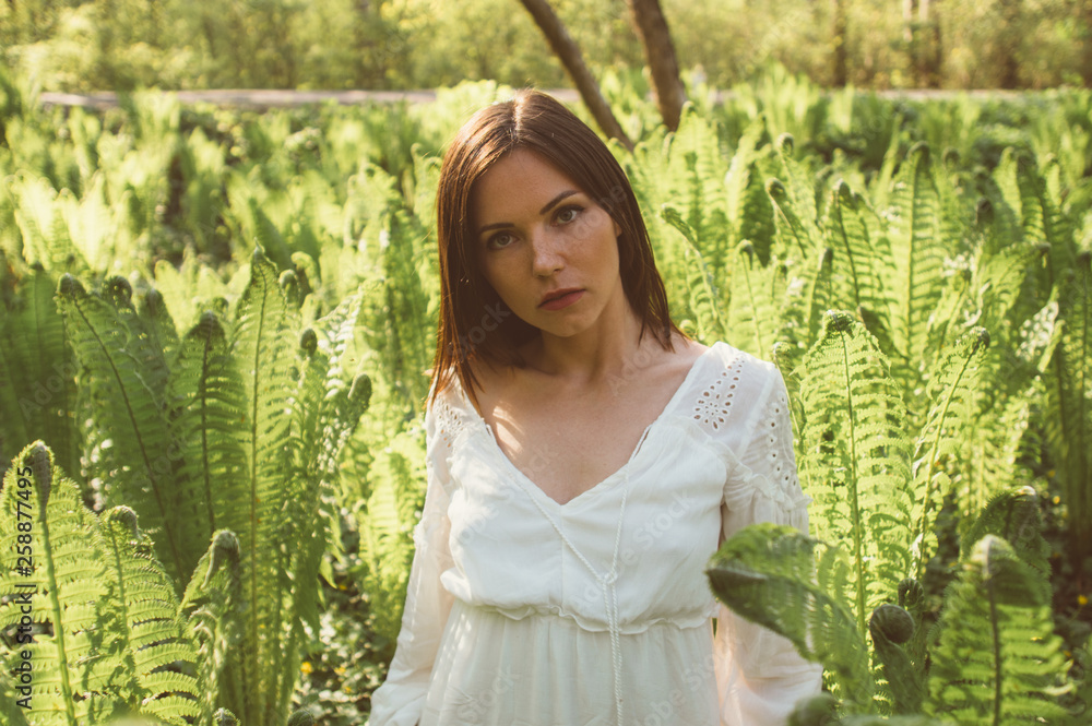 Beautiful brunette girl posing in fern