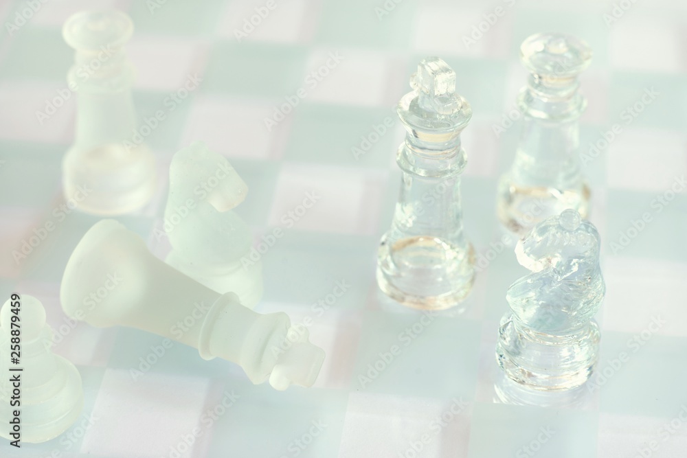 Chess board game made of glass, business competitive concept Chess board game made of glass, business competitive concept