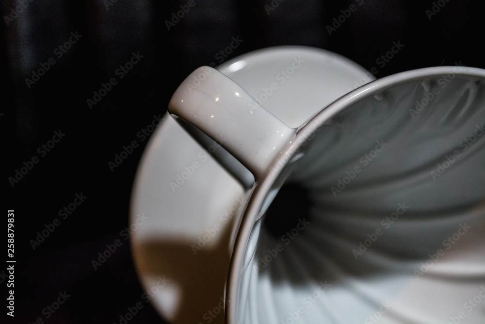 White funnel Pourover on a black background for preparation of coffee by an alternative method. Work the barista in coffee shop. 