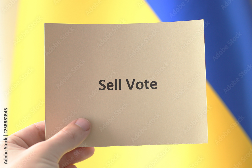 hand hold paper card with words vote. concept sell vote. ukraine president campaign 2019. hand hold paper card with words vote. concept sell vote. ukraine president campaign 2019.
