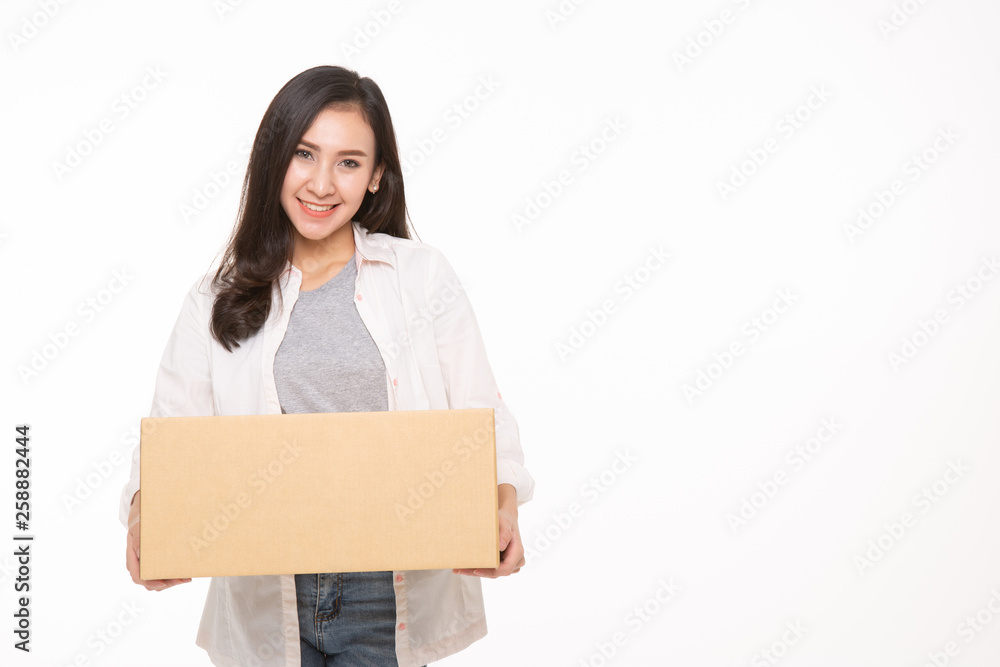 Delivery, relocation and unpacking. Smiling young woman holding cardboard box isolated on white background Delivery, relocation and unpacking. Smiling young woman holding cardboard box isolated on white background