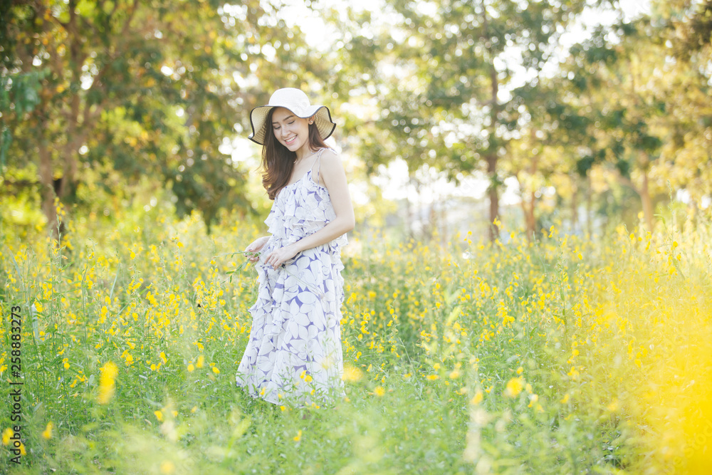 happy young woman enjoying summer in yellow flower field happy young woman enjoying summer in yellow flower field