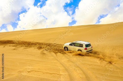 Offroad desert safari, dune bashing at Khor Al Udeid, the inland sea near Qatar and Saudi Arabian, Persian Gulf, Middle East. Inland sea is a major tourist destination for Qatar. © bennymarty
