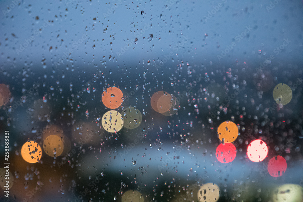 Raindrops on Window city light background Raindrops on Window city light background