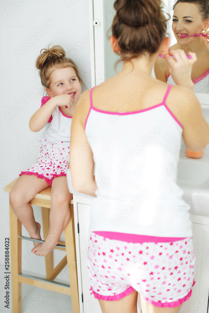 Woman and child brush their teeth Woman and child brush their teeth