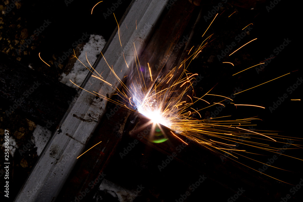 Sparks from welding at a construction site as a background Sparks from welding at a construction site as a background