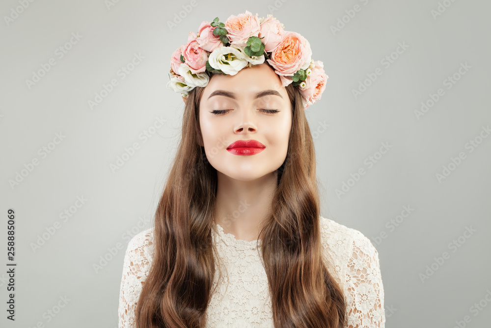 Beauty Fashion Portrait of Beautiful Model Woman with Curly Hair, Makeup and Flowers