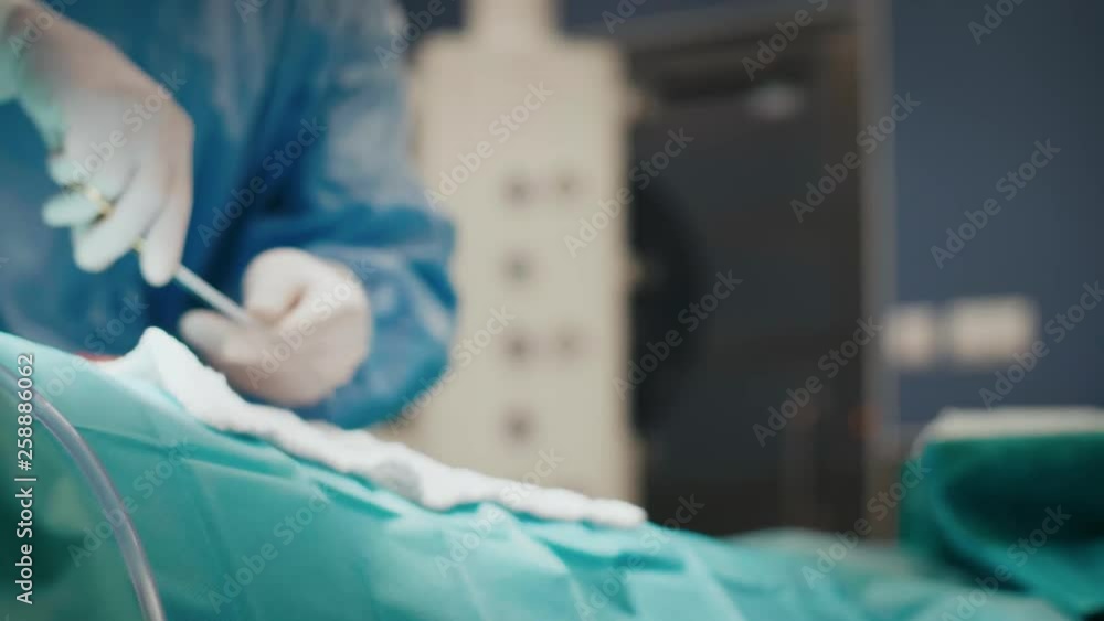 Surgeon using medical scissors during an operation Surgeon using medical scissors during an operation