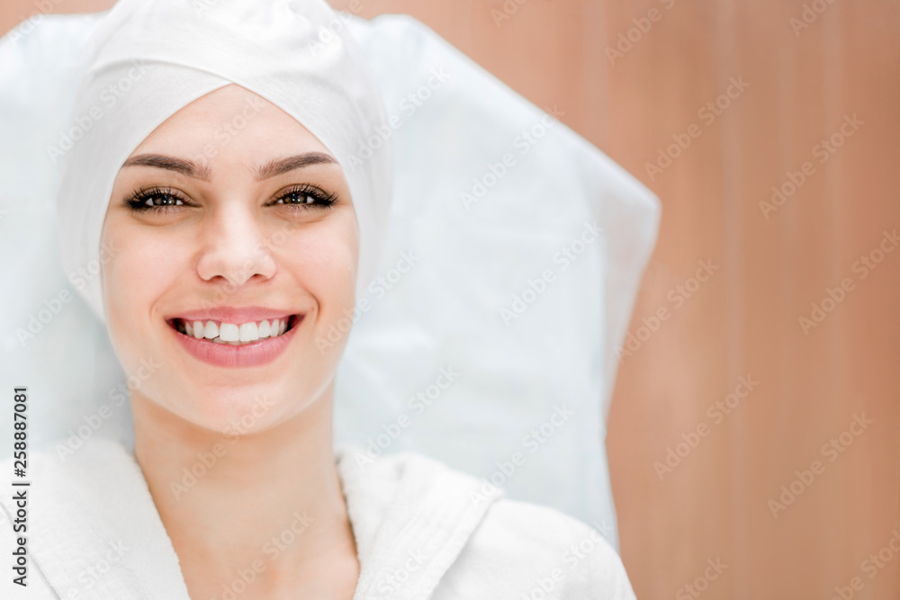 Smiling girl in the office at the beautician, ready for the procedure on the face. Rejuvenation, face lift. Smiling girl in the office at the beautician, ready for the procedure on the face. Rejuvenation, face lift.