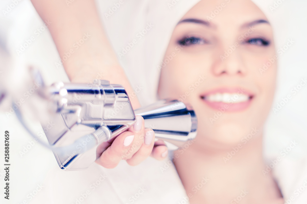 Cosmetology. Close-up of a laser apparatus nozzle, procedure in progress. Face treatment. Cosmetology. Close-up of a laser apparatus nozzle, procedure in progress. Face treatment.