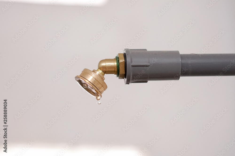 Water tap shower on a pipe long with pouring water at nozzle sprayer Water tap shower on a pipe long with pouring water at nozzle sprayer