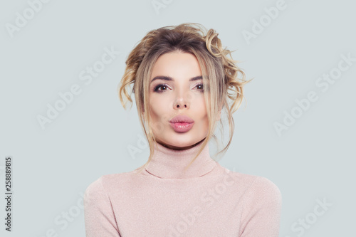 Wallpaper Mural Portrait of pretty woman in pink turtleneck on white background. Model thinking, funny face Torontodigital.ca