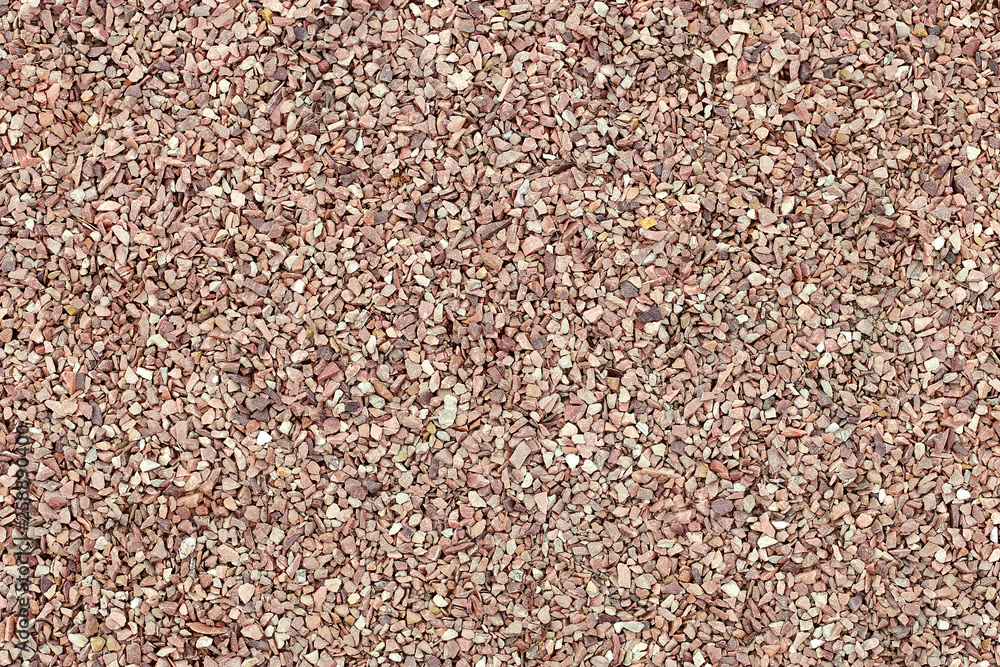 Red crushed stone, uniform coating. Industrial background. Red crushed stone, uniform coating. Industrial background.