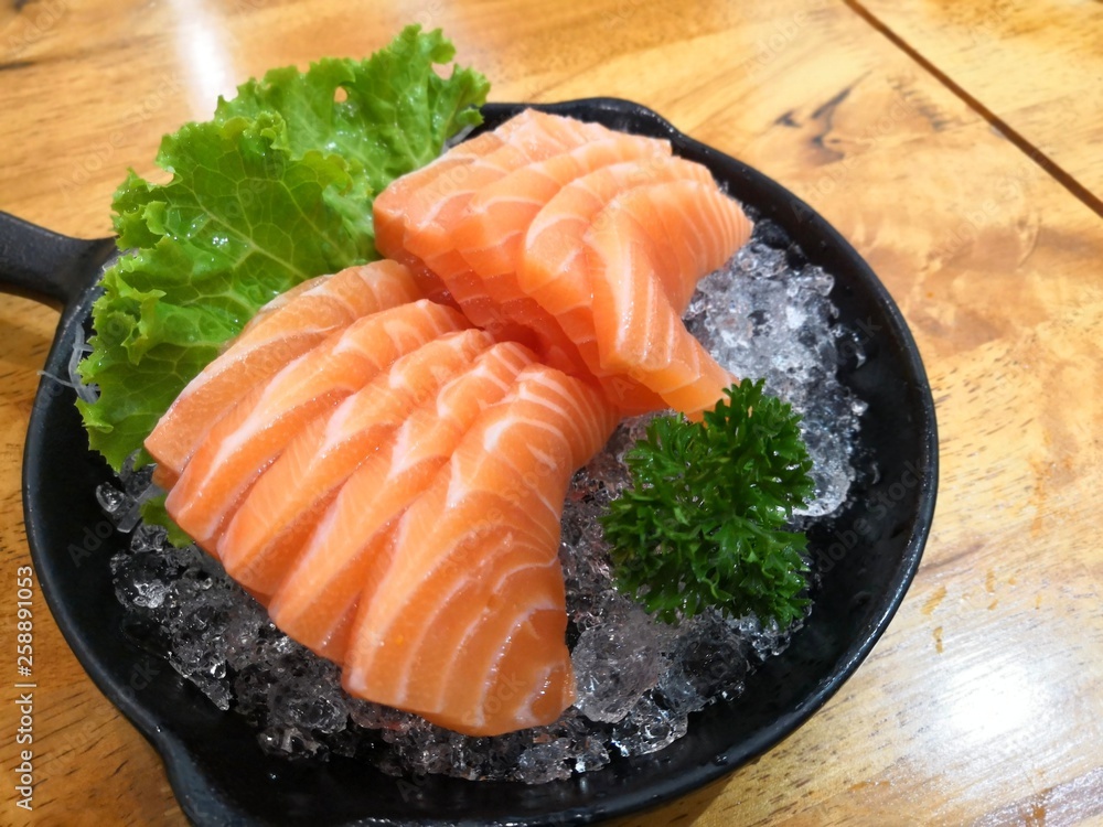 Salmon Sashimi on ice with vegetable - japanese food style. Salmon Sashimi on ice with vegetable - japanese food style.