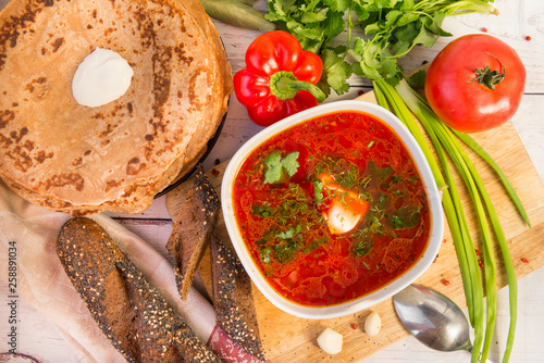 soup, borsch with greens and sour cream, pancakes with sour cream, tomato, bell pepper, onion, parsley, bread
